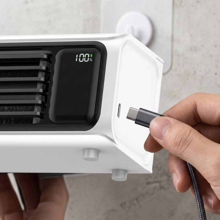 A hand plugging a USB-C cable into the base of the FrostyLax cooler tower